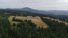 5.7K aerial stock footage of a stationary view of a farm and fields, Hood River, Oregon Aerial Stock Footage | DX0001_015_013