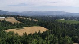 5.7K aerial stock footage of evergreen trees and brown hills in Hood River, Oregon Aerial Stock Footage | DX0001_017_019