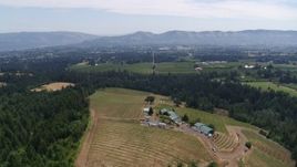 5.7K aerial stock footage of descending toward hilltop buildings and grapevines at Phelps Creek Vineyards in Hood River, Oregon Aerial Stock Footage | DX0001_017_035