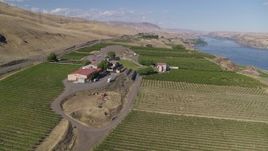 5.7K aerial stock footage of a reverse view of the Maryhill Winery and vineyards beside the Columbia River in Goldendale, Washington Aerial Stock Footage | DX0001_018_011