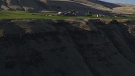 5.7K aerial stock footage fly over cliff and vineyard toward the Maryhill Winery in Goldendale, Washington Aerial Stock Footage | DX0001_019_027