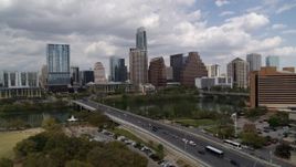 5.7K aerial stock footage the city's skyline while passing First Street Bridge and Lady Bird Lake, Downtown Austin, Texas Aerial Stock Footage | DX0002_102_002