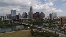 5.7K aerial stock footage slowly pass First Street Bridge and Lady Bird Lake with view of skyline, Downtown Austin, Texas Aerial Stock Footage | DX0002_102_004