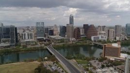 5.7K aerial stock footage of First Street Bridge spanning Lady Bird Lake with view of skyline, Downtown Austin, Texas Aerial Stock Footage | DX0002_102_006