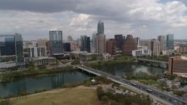 5.7K aerial stock footage of First Street Bridge and Lady Bird Lake with view of the city skyline, Downtown Austin, Texas Aerial Stock Footage | DX0002_102_008
