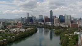 5.7K aerial stock footage approach the city skyline from Lady Bird Lake, Downtown Austin, Texas Aerial Stock Footage | DX0002_102_016