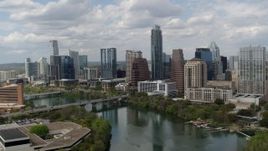 5.7K aerial stock footage approach the city skyline from Lady Bird Lake and ascend, Downtown Austin, Texas Aerial Stock Footage | DX0002_102_018