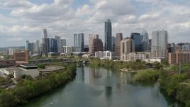 5.7K aerial stock footage of a reverse view of the city skyline while flying over Lady Bird Lake, Downtown Austin, Texas Aerial Stock Footage | DX0002_102_020