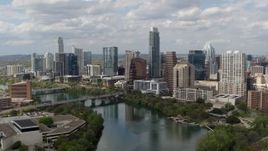 5.7K aerial stock footage fly away from the city skyline and ascend over Lady Bird Lake, Downtown Austin, Texas Aerial Stock Footage | DX0002_102_022