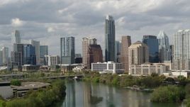 5.7K aerial stock footage fly away from skyscrapers, descend toward Lady Bird Lake in Downtown Austin, Texas Aerial Stock Footage | DX0002_103_002
