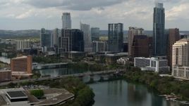 5.7K aerial stock footage fly away from bridge spanning Lady Bird Lake near skyscrapers in Downtown Austin, Texas Aerial Stock Footage | DX0002_103_013