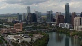 5.7K aerial stock footage fly away from bridge over Lady Bird Lake near waterfront skyscrapers in Downtown Austin, Texas Aerial Stock Footage | DX0002_103_014
