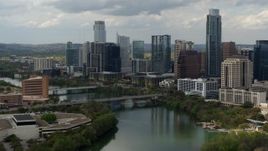 5.7K aerial stock footage approach and flyby bridge across Lady Bird Lake by waterfront skyscrapers in Downtown Austin, Texas Aerial Stock Footage | DX0002_103_015