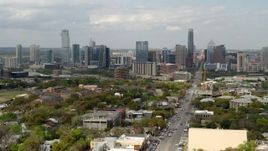5.7K aerial stock footage of passing Congress Avenue with view of the city's skyline in Downtown Austin, Texas Aerial Stock Footage | DX0002_103_021