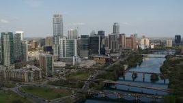 5.7K aerial stock footage a reverse view of skyscrapers and bridges spanning Lady Bird Lake, Downtown Austin, Texas Aerial Stock Footage | DX0002_104_003
