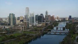 5.7K aerial stock footage descend by Lady Bird Lake with view of bridges and skyscrapers, Downtown Austin, Texas Aerial Stock Footage | DX0002_104_004