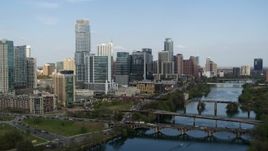 5.7K aerial stock footage approach Lady Bird Lake with view of bridges and skyscrapers, Downtown Austin, Texas Aerial Stock Footage | DX0002_104_005