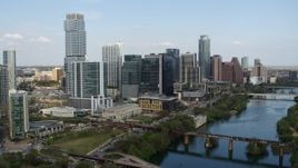 5.7K aerial stock footage tall skyscrapers seen while flying by bridges over Lady Bird Lake, Downtown Austin, Texas Aerial Stock Footage | DX0002_104_006