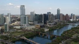 5.7K aerial stock footage approaching towering skyscrapers and bridges over Lady Bird Lake, Downtown Austin, Texas Aerial Stock Footage | DX0002_104_012