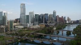 5.7K aerial stock footage fly away from towering skyscrapers and bridges over Lady Bird Lake, Downtown Austin, Texas Aerial Stock Footage | DX0002_104_013