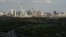 5.7K aerial stock footage of a wide view of city's towering skyline seen from green parks, Downtown Austin, Texas Aerial Stock Footage | DX0002_104_021