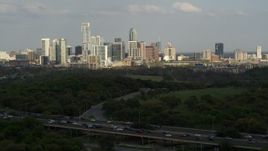 5.7K aerial stock footage of a wide view of city's towering skyline, descend near freeway, Downtown Austin, Texas Aerial Stock Footage | DX0002_104_022