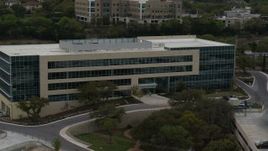5.7K aerial stock footage approach and orbit a modern office building in Austin, Texas Aerial Stock Footage | DX0002_104_029