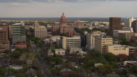 5.7K aerial stock footage of passing by the Texas State Capitol building at sunset in Downtown Austin, Texas Aerial Stock Footage | DX0002_104_034