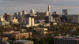 5.7K aerial stock footage fly away from a courthouse and office buildings near skyscrapers at sunset in Downtown Austin, Texas, and descend Aerial Stock Footage | DX0002_104_043