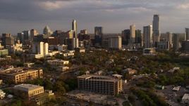 5.7K aerial stock footage of flying away from skyscrapers and office buildings at sunset in Downtown Austin, Texas Aerial Stock Footage | DX0002_105_003