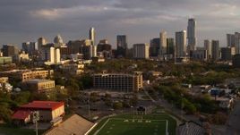 5.7K aerial stock footage of skyscrapers seen from football field at sunset in Downtown Austin, Texas Aerial Stock Footage | DX0002_105_005
