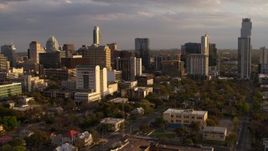5.7K aerial stock footage of office buildings and skyscrapers behind courthouse at sunset in Downtown Austin, Texas Aerial Stock Footage | DX0002_105_009