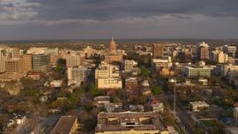 5.7K aerial stock footage Texas State Capitol dome and office buildings at sunset before descent in Downtown Austin, Texas Aerial Stock Footage | DX0002_105_014
