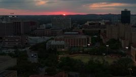 5.7K aerial stock footage slowly passing by the university campus with setting sun in distance, Austin, Texas Aerial Stock Footage | DX0002_105_032