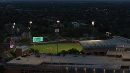5.7K aerial stock footage of ascending by baseball stadium at the University of Texas at twilight, Austin, Texas Aerial Stock Footage | DX0002_105_037