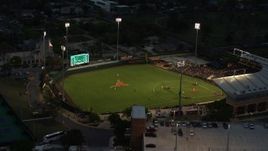5.7K aerial stock footage flyby a baseball game at a stadium at the University of Texas at twilight, Austin, Texas Aerial Stock Footage | DX0002_105_039