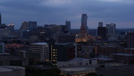 5.7K aerial stock footage of office buildings around capitol at twilight, skyscrapers in distance in Downtown Austin, Texas Aerial Stock Footage | DX0002_105_042