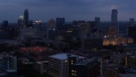 5.7K aerial stock footage of descending by office buildings, capitol and skyscrapers at twilight in Downtown Austin, Texas Aerial Stock Footage | DX0002_105_047