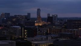 5.7K aerial stock footage descend near office buildings with view of state capitol at twilight in Downtown Austin, Texas Aerial Stock Footage | DX0002_105_052