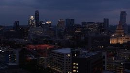 5.7K aerial stock footage descend with view of office buildings, skyscrapers near capitol at twilight in Downtown Austin, Texas Aerial Stock Footage | DX0002_105_054