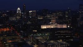 5.7K aerial stock footage reverse view of office buildings, skyscrapers and capitol at night in Downtown Austin, Texas Aerial Stock Footage | DX0002_106_003
