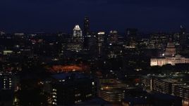 5.7K aerial stock footage of passing by office buildings, skyscrapers and capitol at night in Downtown Austin, Texas Aerial Stock Footage | DX0002_106_004