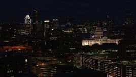 5.7K aerial stock footage flyby skyscrapers and office buildings behind Texas State Capitol at night in Downtown Austin, Texas Aerial Stock Footage | DX0002_106_012