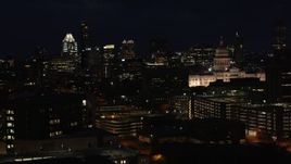 5.7K aerial stock footage slow pass by skyscrapers, office buildings, Texas State Capitol at night in Downtown Austin, Texas Aerial Stock Footage | DX0002_106_013
