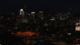 5.7K aerial stock footage slowly descend past skyscrapers and office buildings at night in Downtown Austin, Texas Aerial Stock Footage | DX0002_106_016