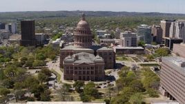 5.7K aerial stock footage of a reverse view of the Texas State Capitol in Downtown Austin, Texas Aerial Stock Footage | DX0002_107_011