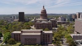 5.7K aerial stock footage descend behind library with view of Texas State Capitol in Downtown Austin, Texas Aerial Stock Footage | DX0002_107_012