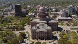 5.7K aerial stock footage of flying away from the Texas State Capitol dome in Downtown Austin, Texas Aerial Stock Footage | DX0002_107_014