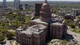 5.7K aerial stock footage orbit the Texas State Capitol building before flying away in Downtown Austin, Texas Aerial Stock Footage | DX0002_107_021