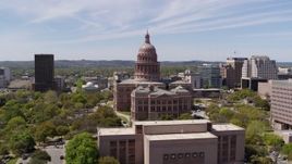 5.7K aerial stock footage fly away from Texas State Capitol, descend near library, Downtown Austin, Texas Aerial Stock Footage | DX0002_107_028